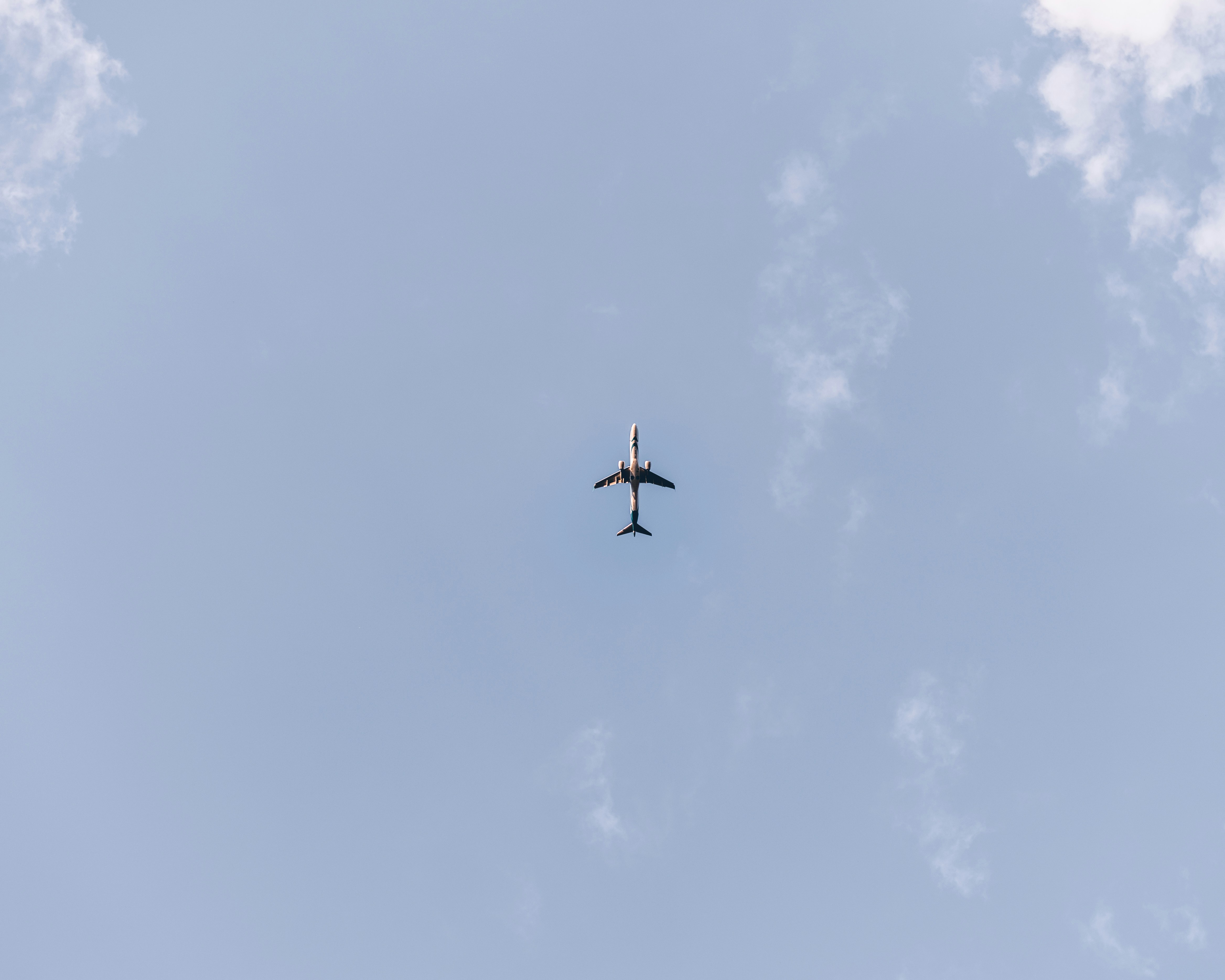 Aircraft flying in beautiful blue sky with white clouds